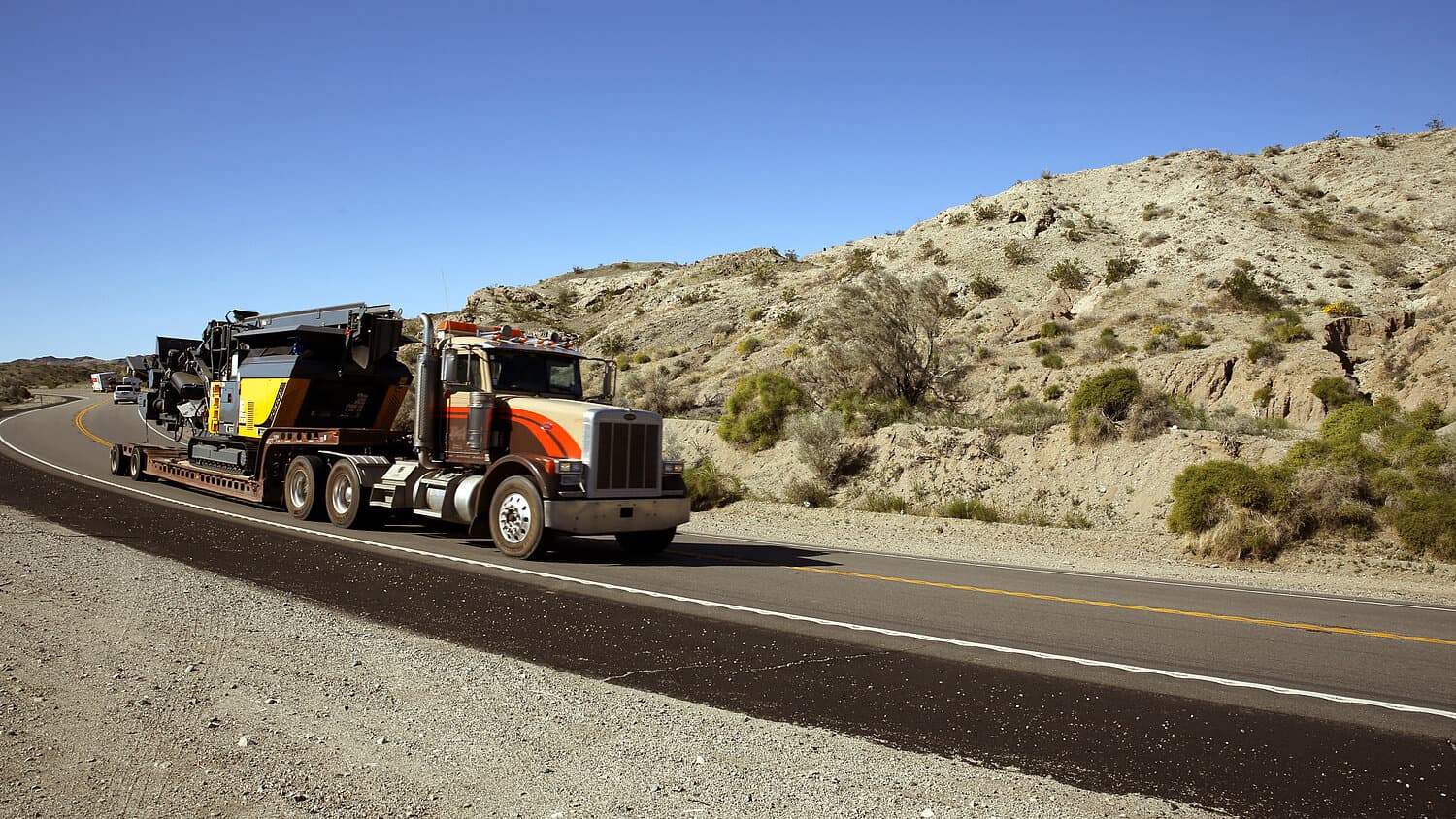 RM 70GO! 2.0 loaded on a lowboy trailer for transport